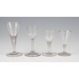 A group of four assorted 18th / early 19th Century drinking glasses; plain trumpet wine glass with