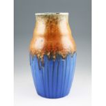 A Ruskin pottery vase of waisted form with a matt drip glaze body having teal and orange coloured