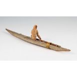 An early 20th Century Inuit kayak toy model, the kayak of wood and shagreen construction with