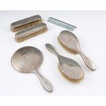 A five piece silver dressing table set comprising of hand mirror, two hand brushes and two hair