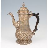 A George II silver coffee pot, of baluster form with repousse curved design to lower body and