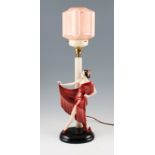 A 1930's Art Deco Keramos, Austria ceramic lamp depicting standing female with red dress next to a