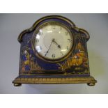 A painted wooden mantle clock with oriental decoration.