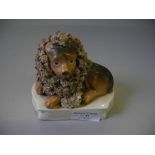 A Staffordshire figure of a lion with lamb.