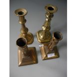Four brass candlestick holders.