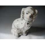 A Staffordshire flat back figure together with a Staffordshire dog.