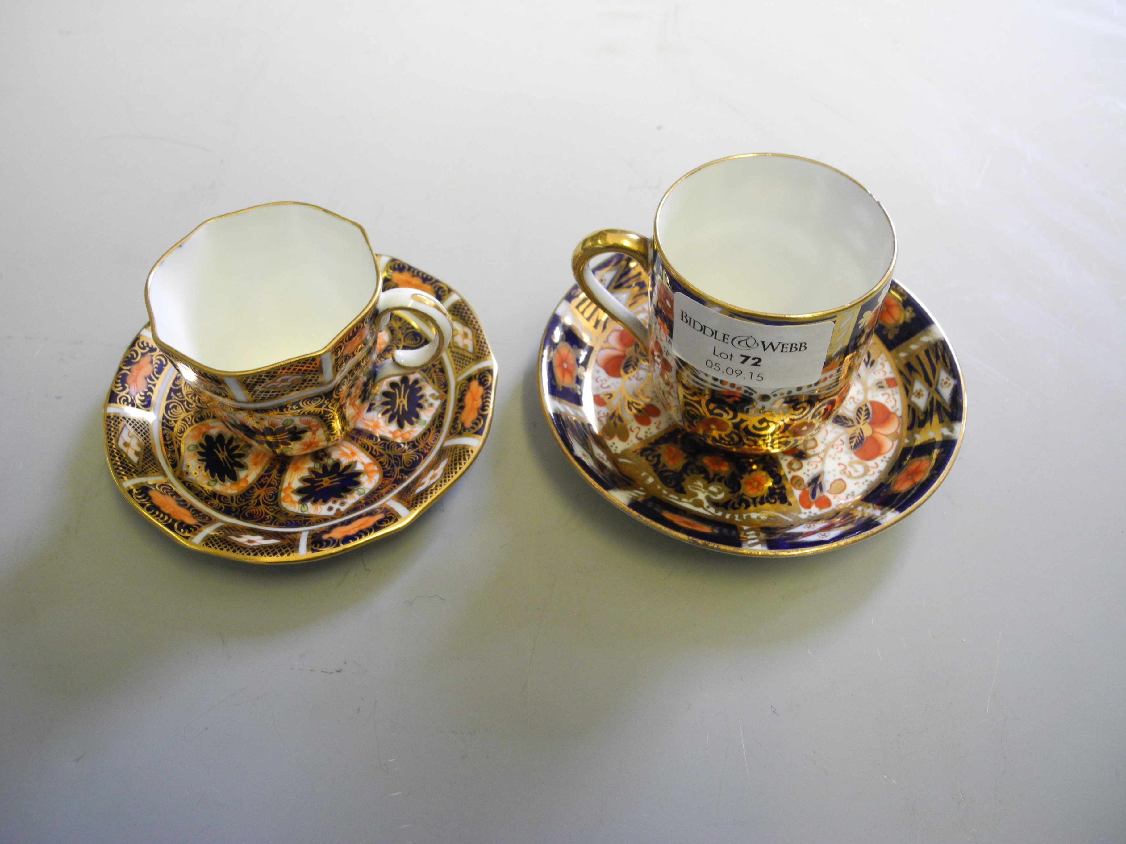 Two Crown Derby cups and saucers.