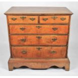 A 19th Century walnut chest of two short over three long drawers with patterned brass handles and