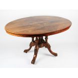A Victorian oval walnut and inlaid tilt top table on turned pillar base with splayed feet, length