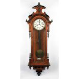 A Victorian mahogany cased Vienna hanging wall clock with brass and enamelled dial with black