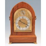 An early 20th Century rosewood cased bracket clock with lightwood inlay and edging, face having