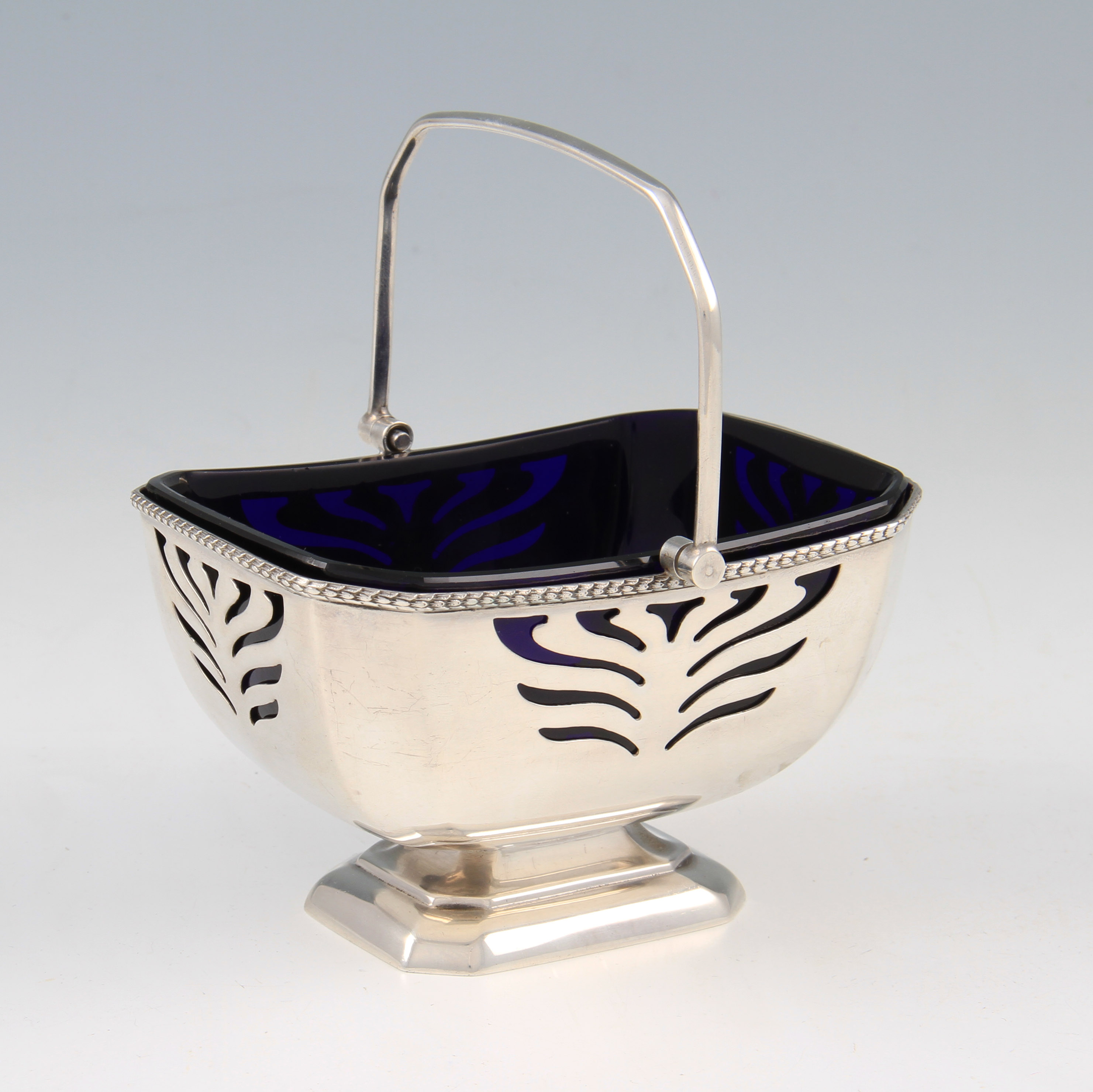 A silver sugar basket, of octagonal form, with pierced repeat pattern to sides, with plain design