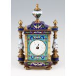 An early 20th Century brass and enamel clock, possibly French, with enamelled floral design on light