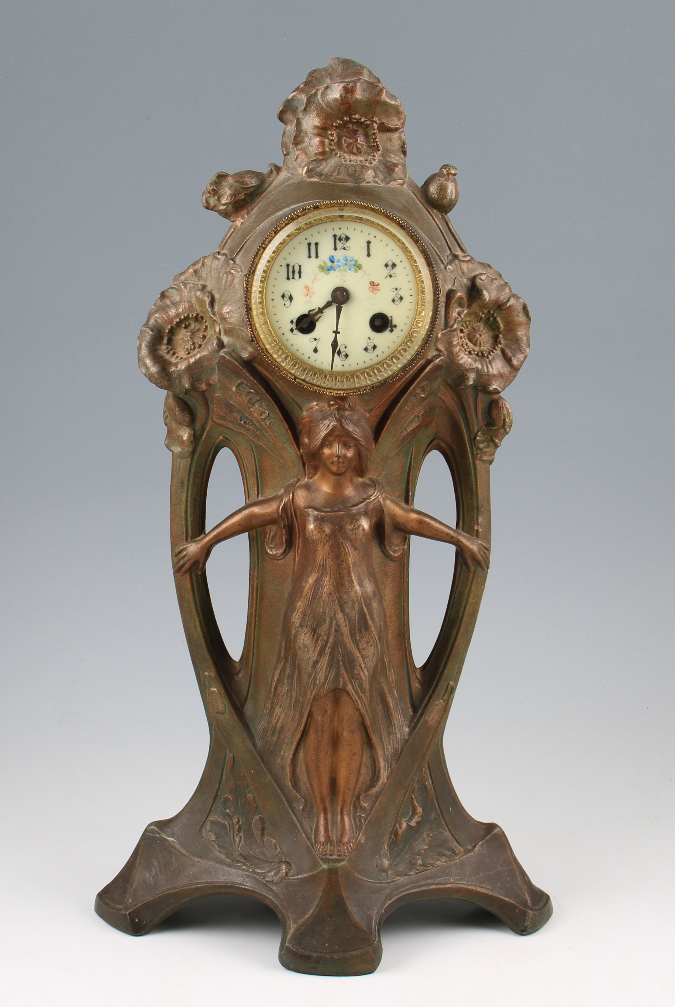 An early 20th Century French Art Nouveau cast metal clock in bronzed finish having central female