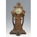 An early 20th Century French Art Nouveau cast metal clock in bronzed finish having central female