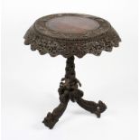 A 19th Century Anglo Indian dark wood carved occasional table with carved border and skirt on a