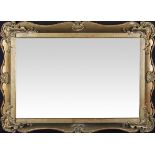 A 19th Century Regency gilt wall mirror with scroll edge design with patterned corners and quarterly