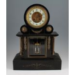 A 19th Century French slate mantel clock, the case having gilt coloured ornate decoration with