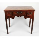 A late 18th Century / 19th Century oak low boy with three fitted drawers with shaped skirting on