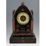 A 19th Century French slate and marble mantel clock with copper coloured detailed patterning, face