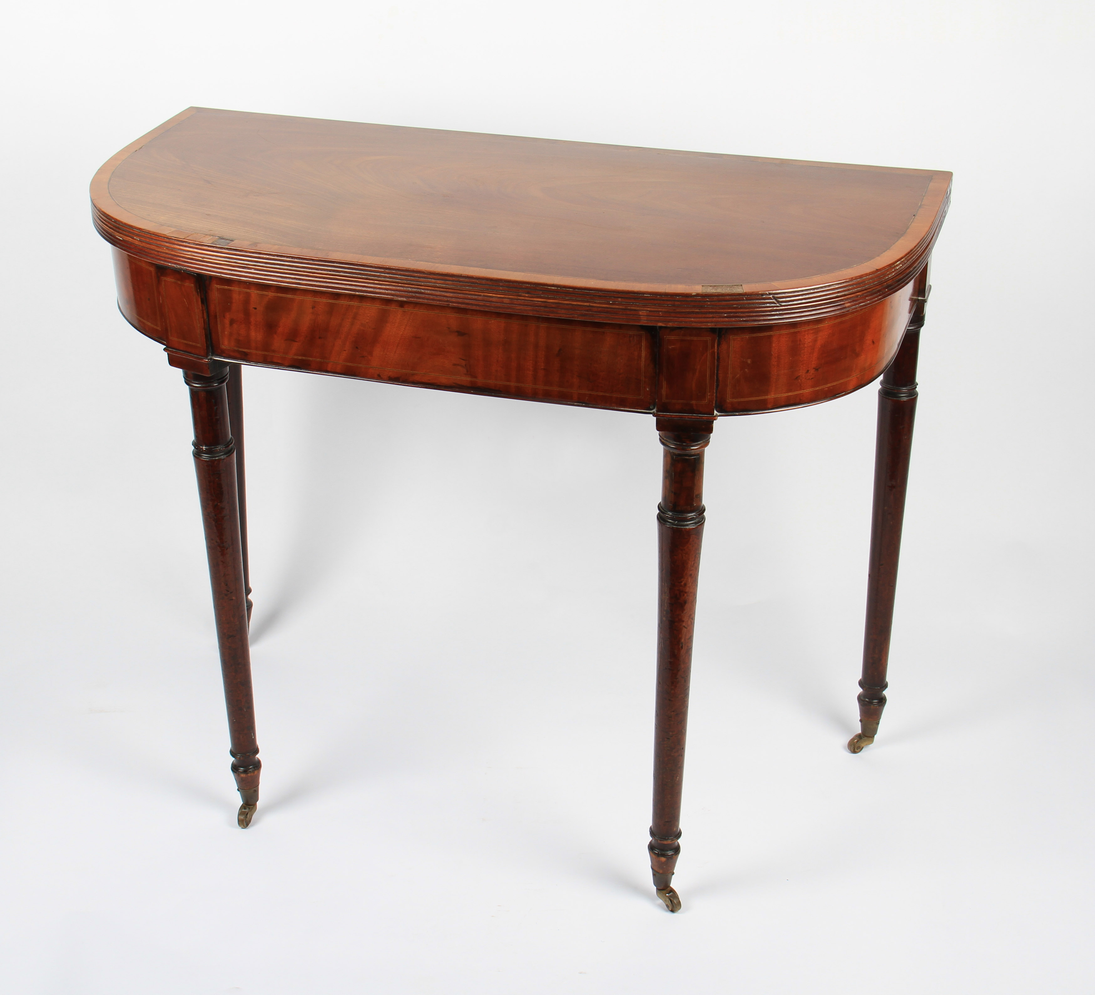 A 19th Century mahogany veneered D end shaped fold over table on turned supports.
