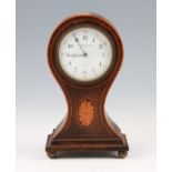 An Edwardian stained oak balloon clock with satinwood stringing and Sheraton style neoclassical