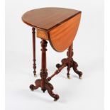 A Victorian mahogany gate leg circular table with light stained inlaid edging on turned supports