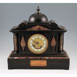 A 19th Century French slate and marble mantel clock with column end supports and central domed top