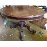 A Victorian oval mahogany tilt top table on carved and shaped base.