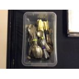 A box of various cutlery sets.