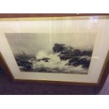 A large framed black and white print of seagulls on rocks with crashing waves, signed Peter