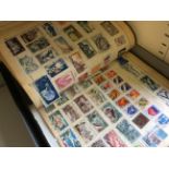 A box contain a variety of stamp albums.