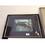 A framed print of a cheetah resting on a forest tree branch, signed.