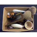 A box of various household items including a teddy bear, a ceramic vase and dish and a set of wooden