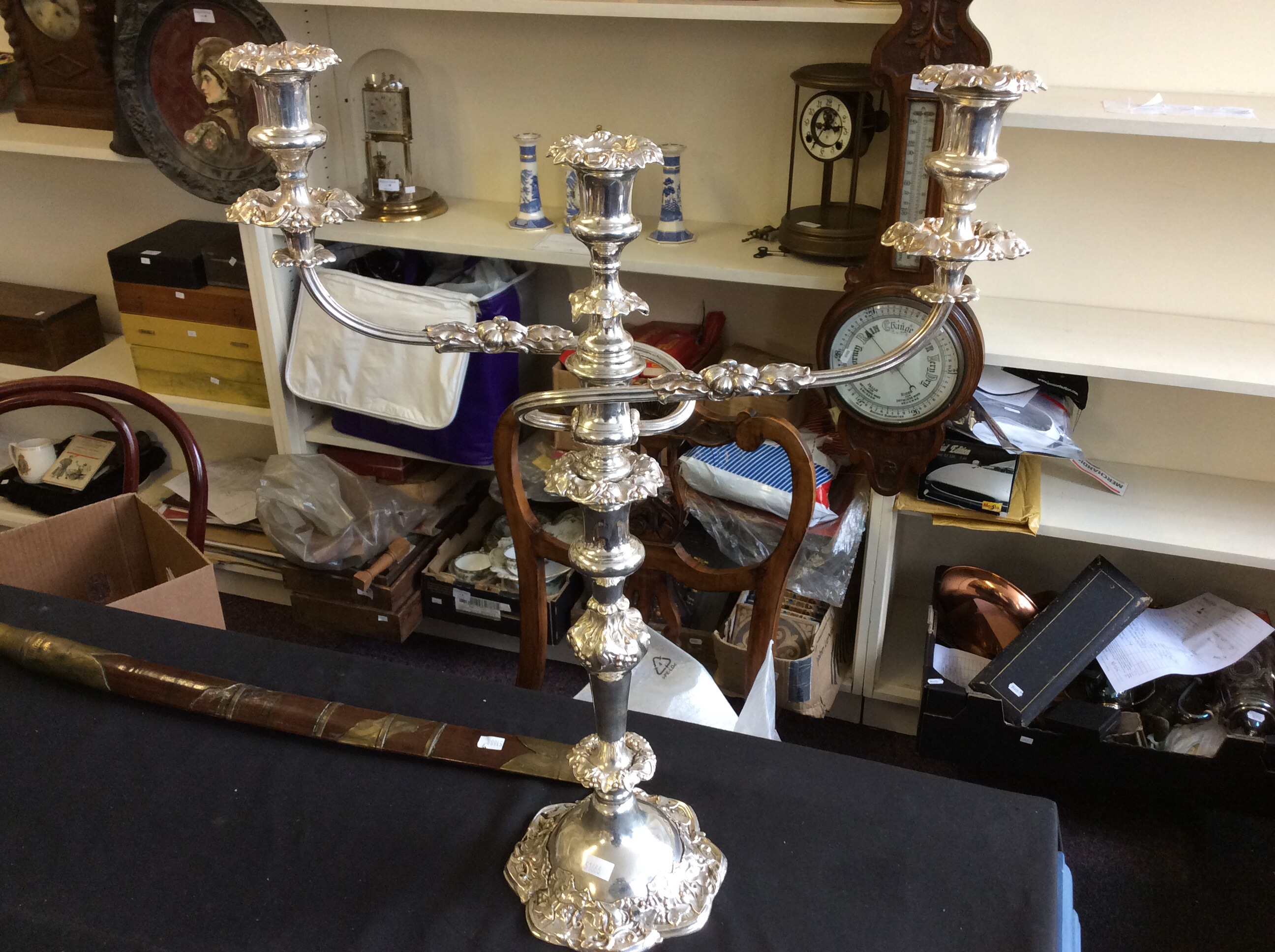 A pair of three branched silver plated candelabras with floral decoration.
