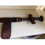 A leather cased African sword.