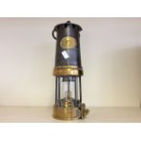 A metal and brass Patterson Lamps Ltd. miner's lamp.
