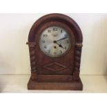 An ornamental mantelpiece clock with barley twist decoration.