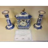 Two Wedgewood willow pattern candlesticks together with a Wedgewood willow pattern clock.