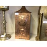 A copper coloured Art Nouveau style mantle clock, decorated with the profile of a lady.