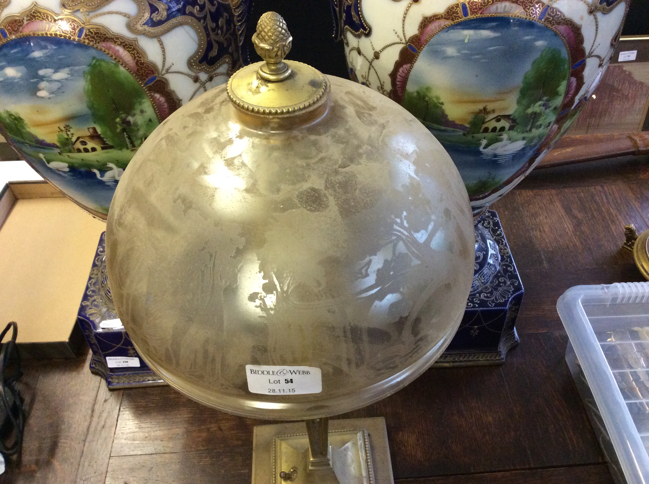 A gilt table lamp with etched glass shade.