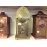 A brass Art Nouveau style mantle clock wiry floral deviation to centre.
