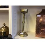 A pair of brass church altar candle holders with fleur de lys decoration.