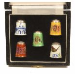 Five enamel decorated silver thimbles, by James Swann & Son, comprising; three floral, a butterfly