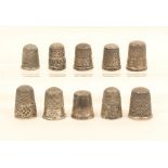 Ten English silver thimbles, most with decorative borders.  (10)