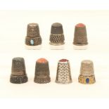 Seven white metal continental thimbles, comprising; three with hardstone tops, two with 'jewelled'