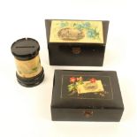 Three larger pieces of black ground Mauchline ware, comprising; a slant top stationery box with