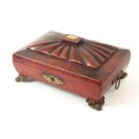 A Regency grained red leather sarcophagus form sewing box, the convex sides below a reeded lid panel