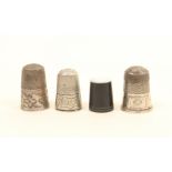 Four thimbles, comprising; a horn example with pearl top, and three early 19th century silver