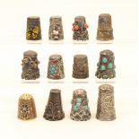 Twelve white metal foreign thimbles, including an example with filigree border, a champlevé enamel